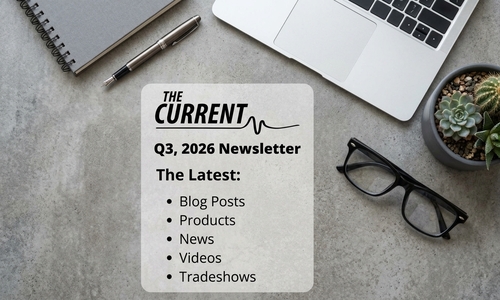 Q3 2026 newsletter titled “The Current” lists blog posts, products, news, videos, and tradeshows on a desk with a laptop, notebook, pen, glasses, and succulents.