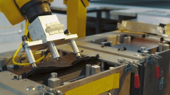 robotic arm picking up an amorphous silicon thin-film solar panel