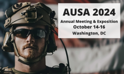 A soldier wearing tactical gear in front of a flag with text promoting AUSA 2024, October 14-16, in Washington, DC.