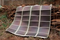 Amorphous silicon thin film foldable solar panel unfolded over rock pile