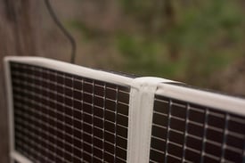 Amorphous silicon thin film foldable solar panel draped over fence Amorphous silicon thin film foldable solar panel draped over fence