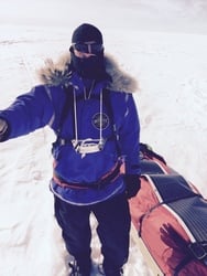 Douglas Tumminello hauling his gear and an amorphous silicon thin film rollable solar panel in the snow