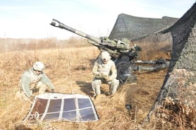 Soldiers using a amorphous silicon thin film foldable solar panel in the field