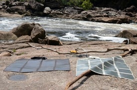 Amorphous silicon thin film solar panel unfolded next to water