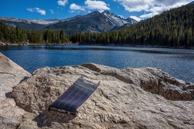 LightSaver Portable Solar Charger on a rock overlooking water