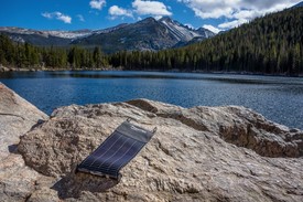 LightSaver Portable Solar Charger on a rock overlooking water LightSaver Portable Solar Charger on a rock overlooking water