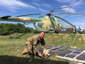 soldier in front of a helicopter