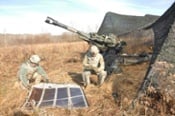 Two soldiers with a foldable solar panel