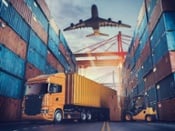 Truck, plane and forklift between stacks of shipping containers