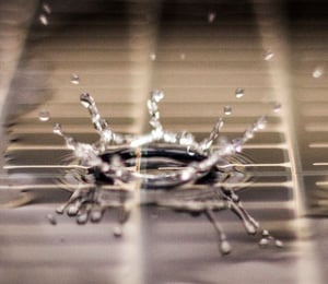 drop of water bouncing on a thin-film amorphous silicon solar panel